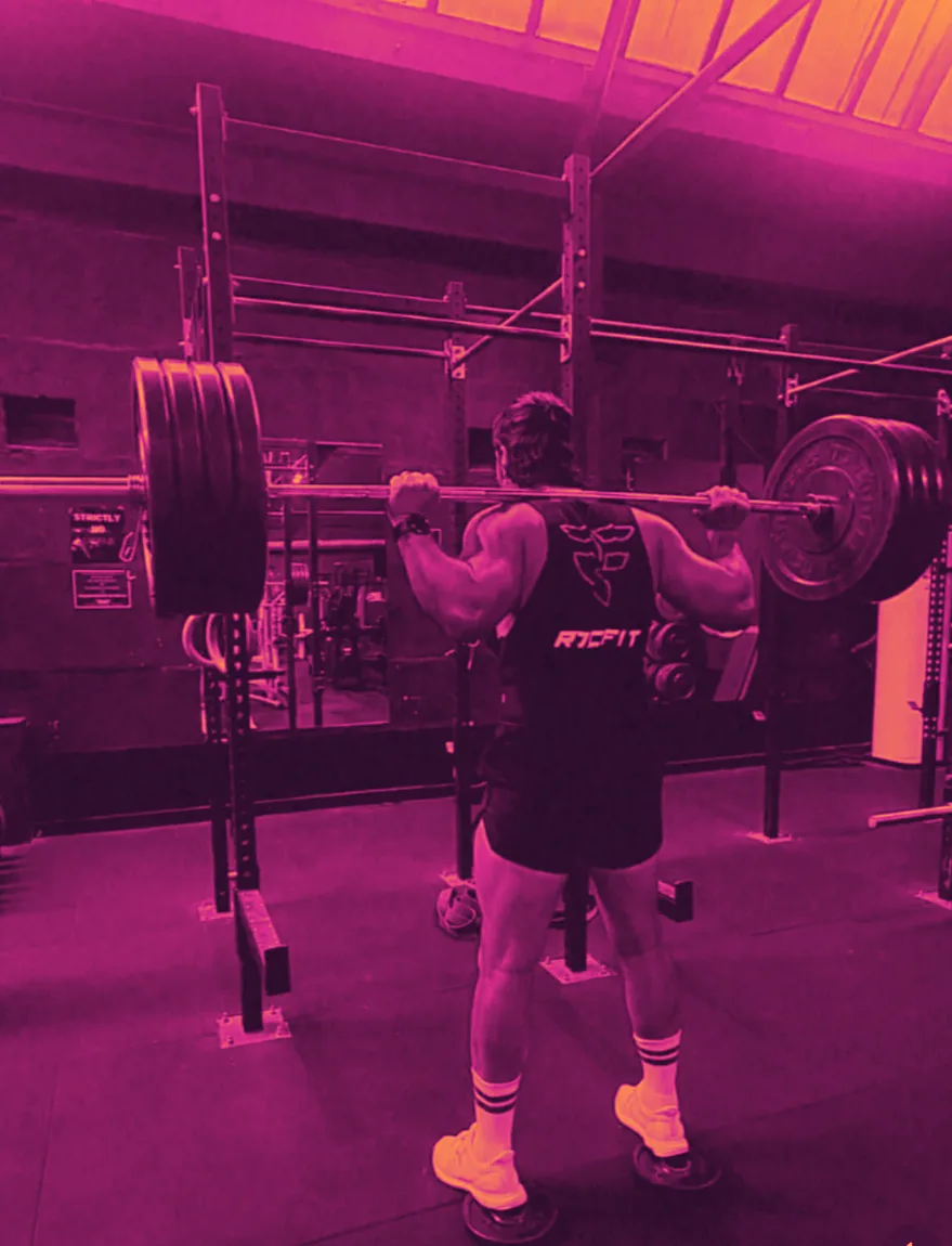 Daniel Rocco mid-squat in the gym